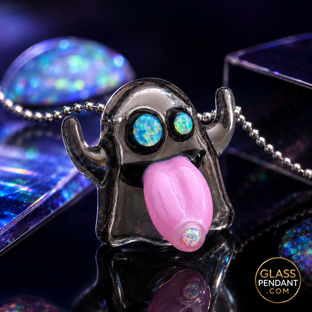 Hand-blown heady glass emoji ghost pendant by leebrodee. Featuring CFL color-changing parallax glass, encased opal eyes, and a dosed opal tongue. Hanging from a ball chain necklace.
