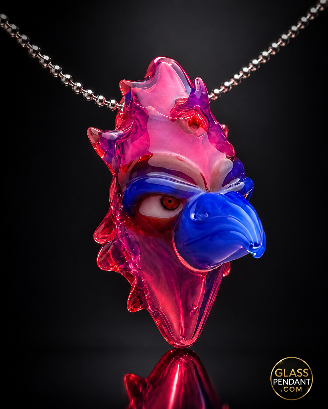 Hand-blown heady glass totem bird pendant by creepglass. Featuring red gold ruby glass. Hanging from a ball chain necklace.